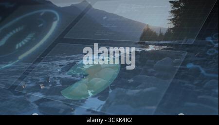 Displaying rocky shoreline by calm lake glowing with digital holograms, with world map overlay Stock Photo