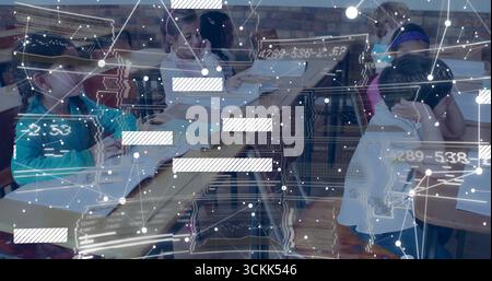 Studying six children reading textbooks and writing notes at classroom desks, with network graphics Stock Photo