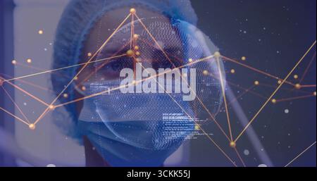Analyzing female healthcare worker wearing bouffant cap and face mask in lab, with network overlay Stock Photo