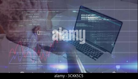 Mature African American man reviewing code with graph overlays at office desk, with laptop Stock Photo