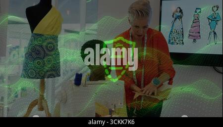 Collaborating two women sewing garment in fashion design studio, with dress form and sewing machine Stock Photo