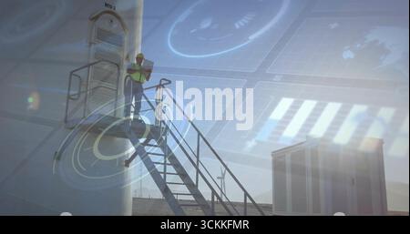 Inspecting technician analyzing tablet on staircase near cabinet at wind farm, with AR, copy space Stock Photo