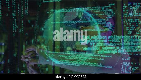 Man wearing casual top and VR headset manipulating holographic globe and code streams in tech lab Stock Photo