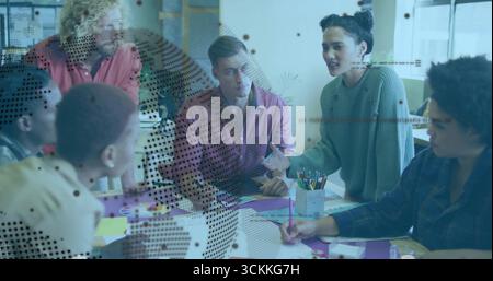 Brainstorming six professionals collaborating around table in office, with papers and partition Stock Photo