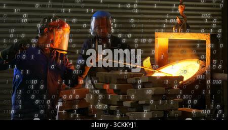 Foundry workers pouring molten metal from crucible in foundry workshop, wearing protective gear Stock Photo