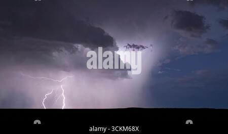 Powerful lightning bolt strikes from a summer monsoon storm Stock Photo