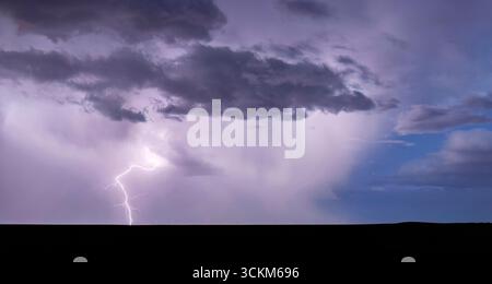 Powerful lightning bolt strikes from a summer monsoon storm in southeast Colorado Stock Photo