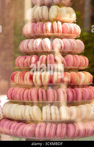 August 28, 2025, Bruges, Belgium — A decorative tower of assorted pink and white macarons stacked on multiple tiers. Stock Photo