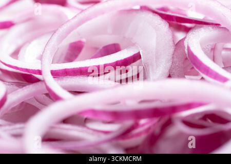 Slices of red onion on white background. Shallow dof Stock Photo