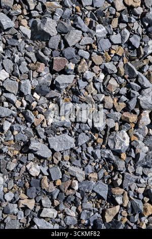 Close-up of gray stones and gravel with rough natural texture, rocky background pattern for construction, building, and industrial design use. Stock Photo