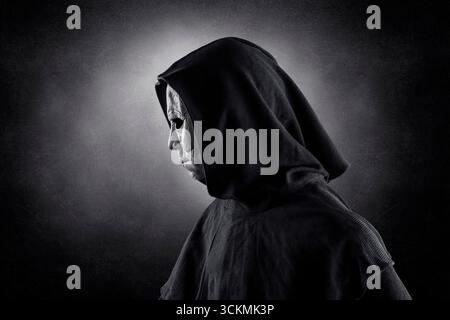 Portrait of a scary figure in hooded cloak Stock Photo - Alamy