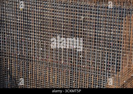 Close-up of a steel construction with visible reinforcement bars. Detail of structural elements at a building site, showcasing engineering materials a Stock Photo