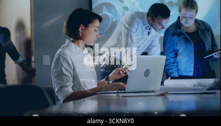 Typing professional using laptop and smartphone in meeting room with schematic overlay, copy space Stock Photo