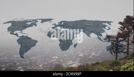 displaying digital map overlay on grassy hillside, with hex grid and data icons amid foggy valley Stock Photo