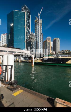Dynamic urban scene featuring a modern city skyline, a bustling waterfront, and clear blue skies. Architectural designs and construction in progress v Stock Photo