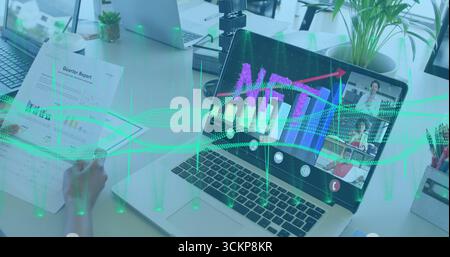 Displaying laptop showing rising bar chart with call windows on office desk, with quarter report Stock Photo