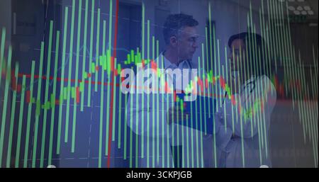 Reviewing two doctors examining patient folder in hospital hall, with stethoscope and chart overlay Stock Photo