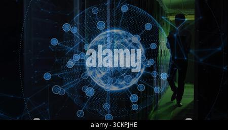 Holographic network globe hovering in data center rack aisle, with silhouetted technician walking Stock Photo