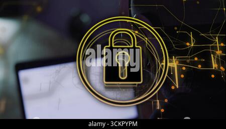Displaying glowing golden padlock icon overlaying blurred laptop screen, with data flow graphics Stock Photo