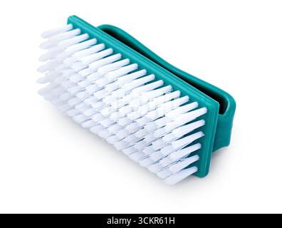 Plastic cleaning brush with white bristles and turquoise handle, lying on a white background Stock Photo