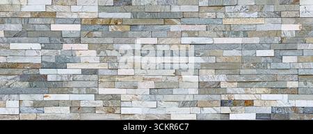 Decorative stone cladding forms a textured wall, ideal for backgrounds and design projects Stock Photo