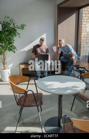 Two knowledgeable professionals collaborating effectively together in a modern workspace setting Stock Photo