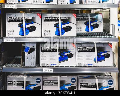 Porsgrunn, Norway - September 13, 2025: Display of various orbital sanders on shelves in a hardware store Stock Photo