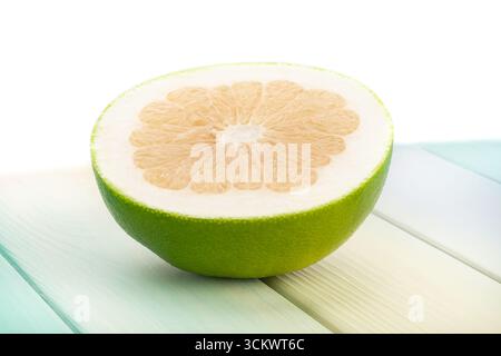 sliced sweetie on wood background on white Stock Photo