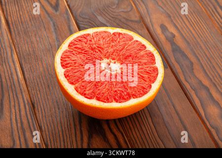 sliced grapefruit on brown wood background Stock Photo