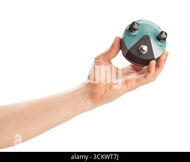 guitar fuzz pedal in hand path isolated on white Stock Photo