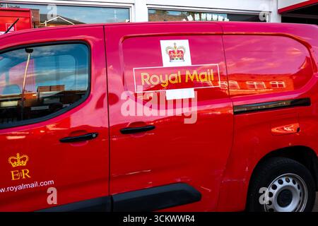 A red Royal Mail delivery van is shown parked outside the sorting office in Bishops Stortford Stock Photo