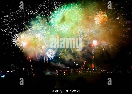 Spectacular bursts of green, gold, and white fireworks illuminate the night sky during Double Tenth National Day celebration at Dadaocheng Wharf in Ta Stock Photo