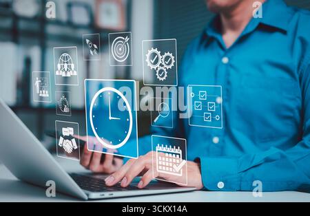 Time Management and Productivity Optimization Concept. Business professional using laptop with digital icons representing time tracking, productivity, Stock Photo
