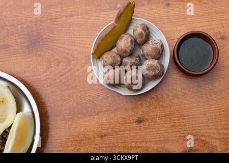 Top view of traditional Canarian wrinkled potatoes served with baked sweet potato and green mojo sauce. Typical food of the Canary Islands, Spanish cu Stock Photo