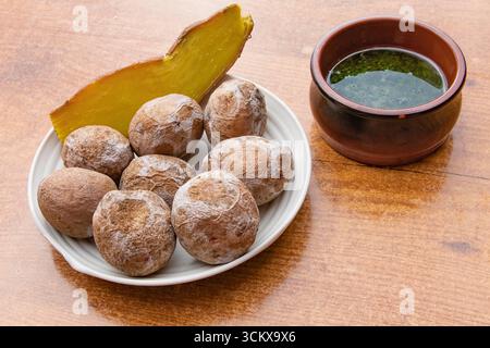 Top view of traditional Canarian wrinkled potatoes served with baked sweet potato and green mojo sauce. Typical food of the Canary Islands, Spanish cu Stock Photo