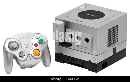 A silver Nintendo GameCube, Wavebird wireless controller, Game Boy Player. Stock Photo