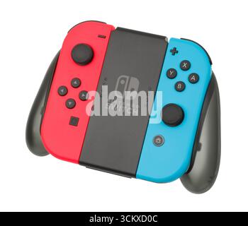 2017 Nintendo Switch Red and blue Joy-Con slotted onto the charging grip, Stock Photo