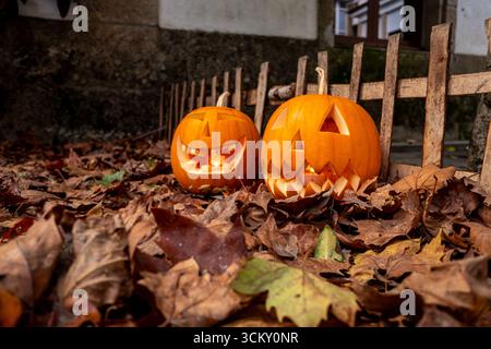 Carved Jack o Lanterns with candles lighting up the dark, October Holiday Stock Photo
