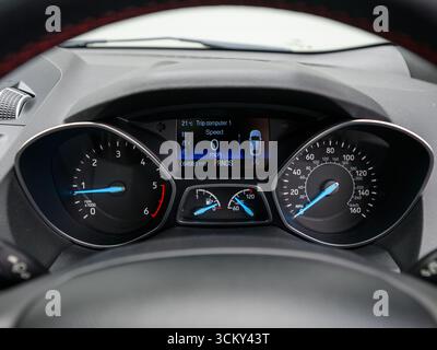 car instrument cluster featuring a speedometer and tachometer, displaying driving speed and engine RPM Stock Photo