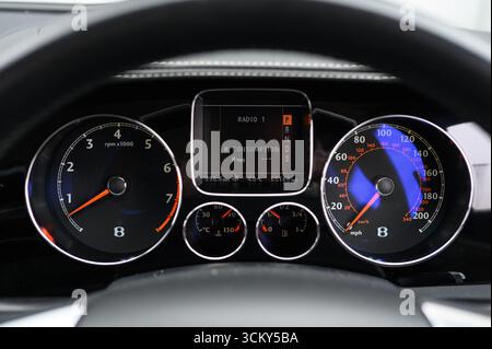car instrument cluster featuring a speedometer and tachometer, displaying driving speed and engine RPM Stock Photo