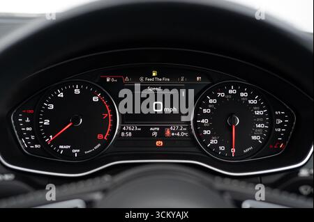 car instrument cluster featuring a speedometer and tachometer, displaying driving speed and engine RPM Stock Photo