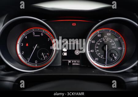 car instrument cluster featuring a speedometer and tachometer, displaying driving speed and engine RPM Stock Photo