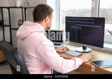 Focused male programmer working in office Stock Photo