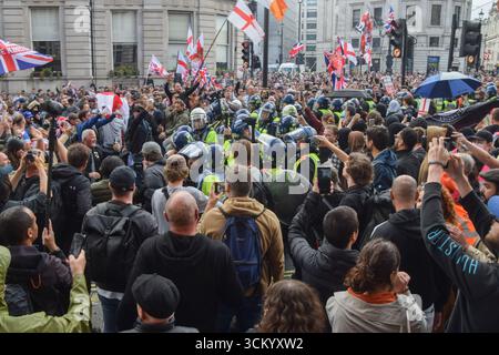 London, UK. 13th Sep, 2025. Riot police keep far-right protesters and anti-fascist counter-protesters apart in Whitehall during the 'Unite The Kingdom' demonstration. Right-wing protesters marched to Westminster and staged a rally against immigration and the government outside Downing Street, organised by far-right activist Tommy Robinson, whose real name is Stephen Yaxley-Lennon. Credit: SOPA Images Limited/Ģ����ý Live News Stock Photo