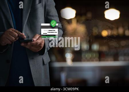 Businessman using smartphone for secure online payment, credit card verification, and mobile banking. Cybersecurity, encryption, and global ecommerce Stock Photo