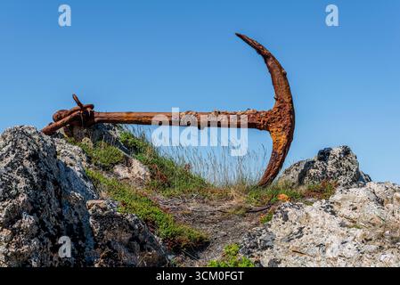 An old, rusty anchor on the shore at Durrell, Newfoundland Stock Photo