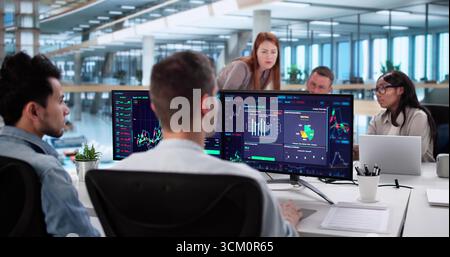 Diverse Team Of Stock Brokers Analyzing Market Trends Together Stock Photo