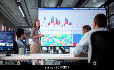 African American Stock Analyst Analyzing Data On Computer At Night. Stock Photo
