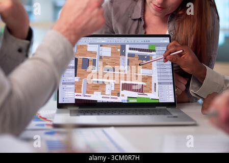 Multiracial Team Using CAD Software To Design Modern Estate Property. Stock Photo