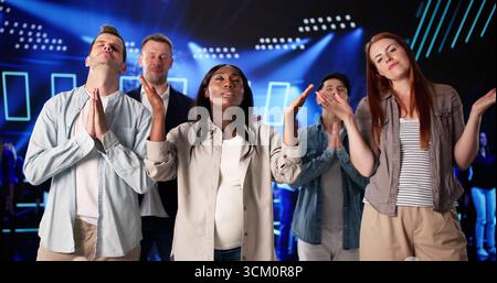 Diverse Group Praying Quietly In Church With Closed Eyes Stock Photo